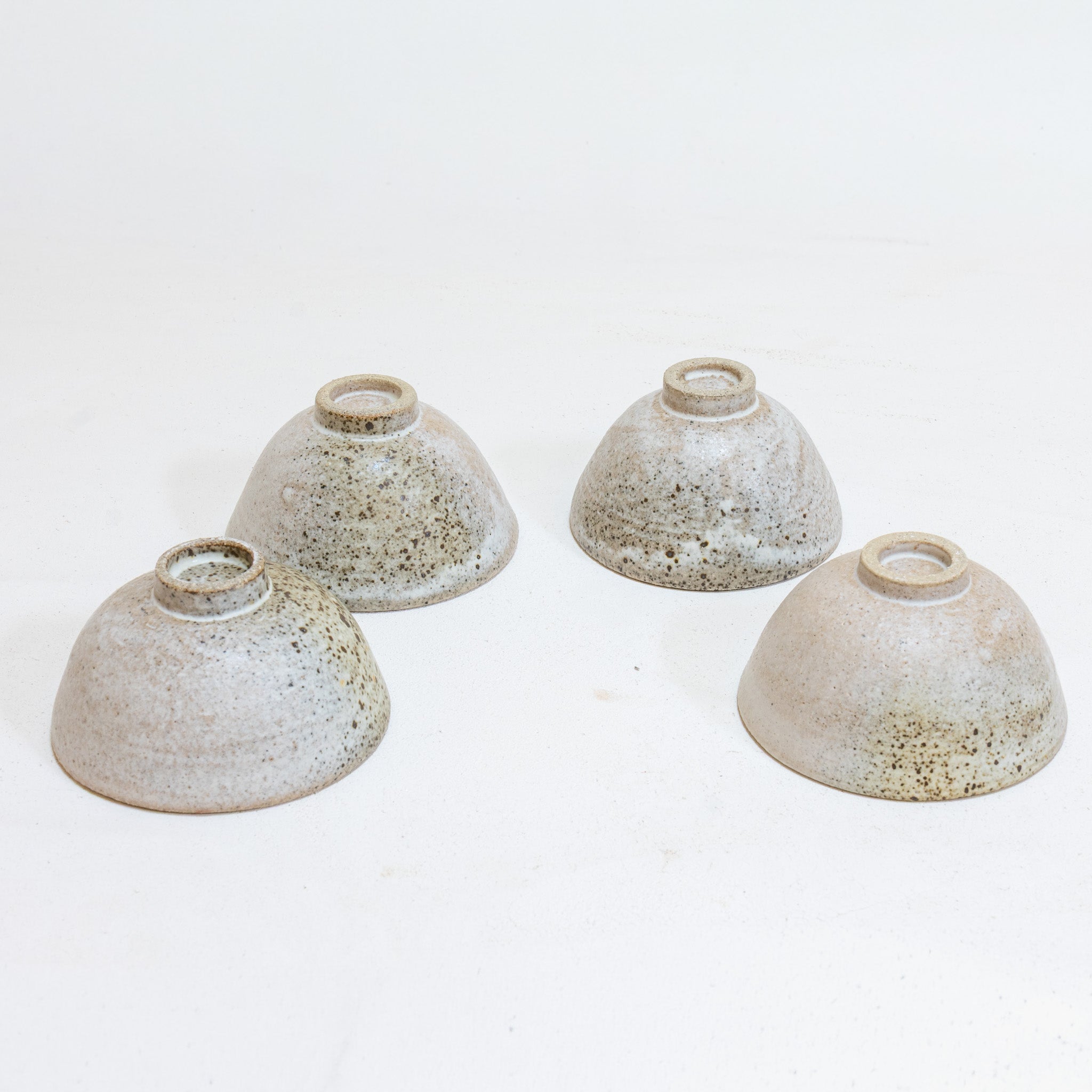 Set of 4 brutal white tea bowls with a quail egg spot