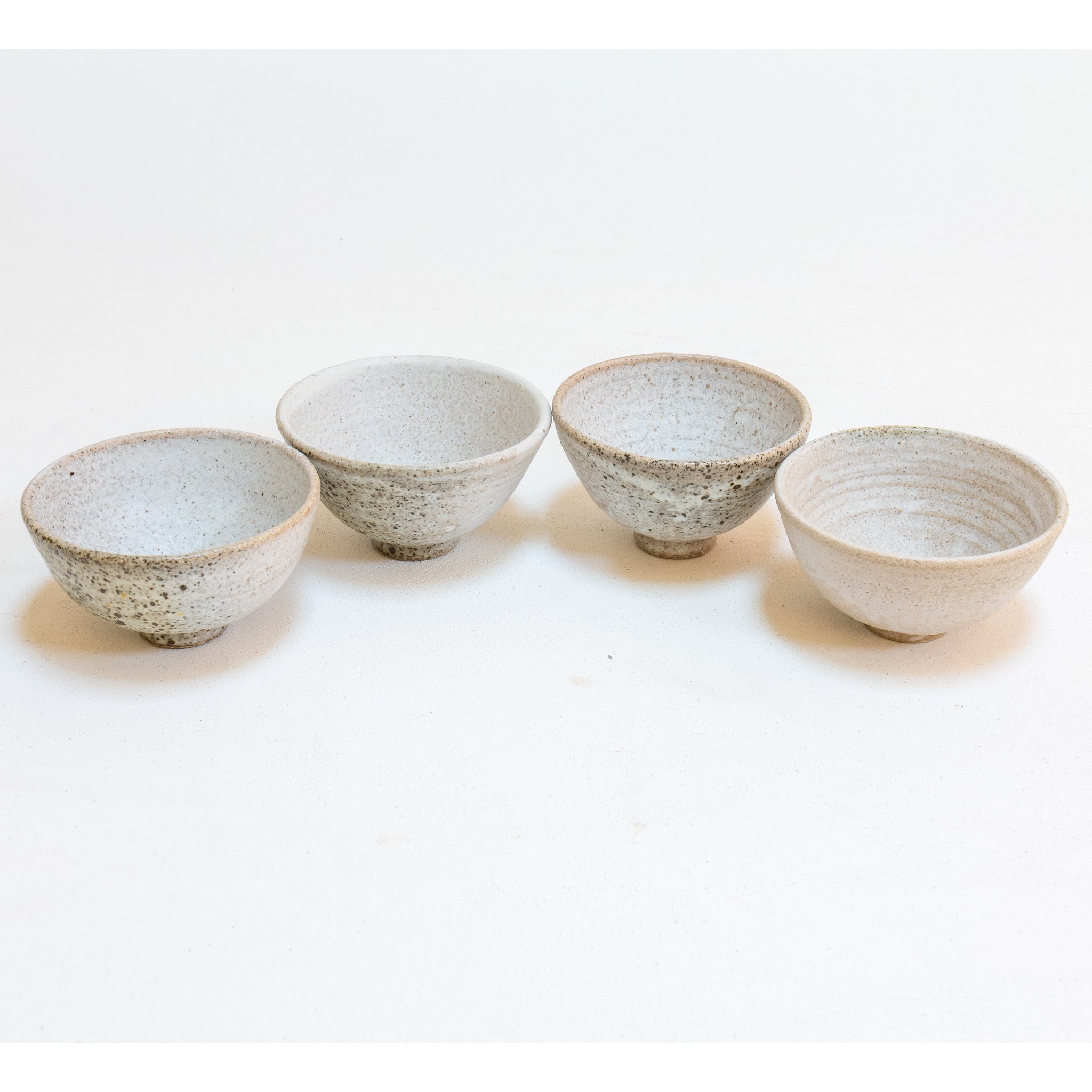 Set of 4 brutal white tea bowls with a quail egg spot