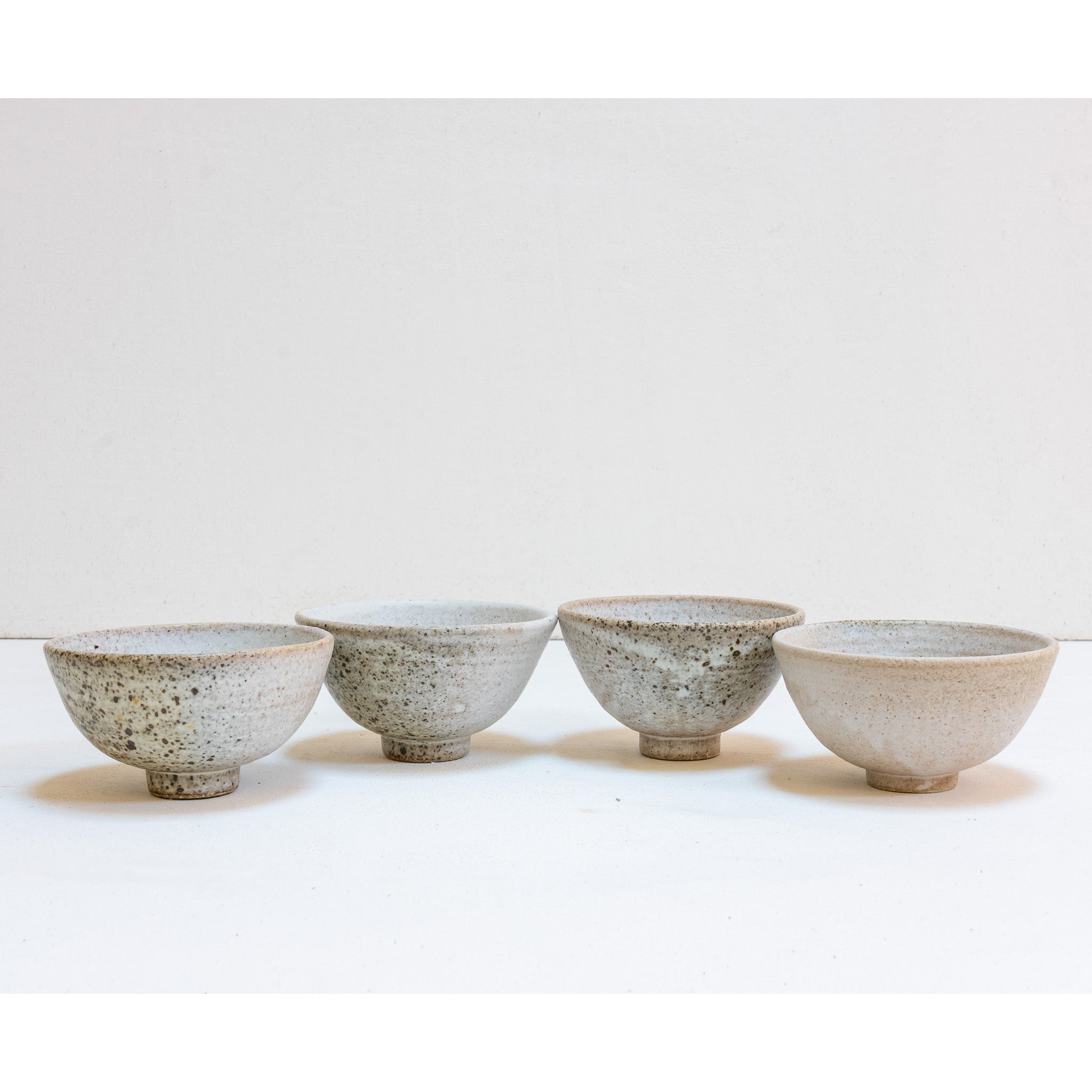 Set of 4 brutal white tea bowls with a quail egg spot