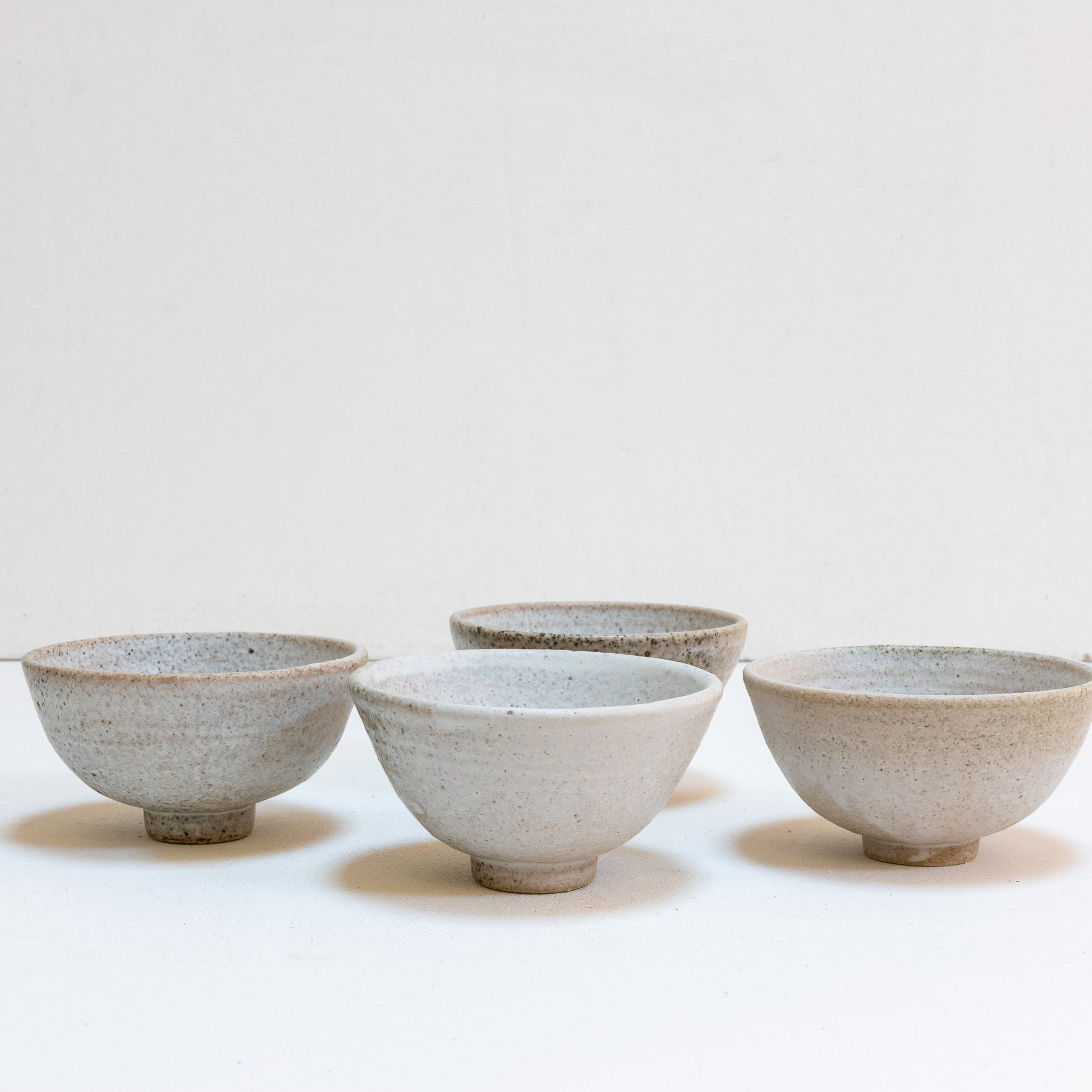 Set of 4 brutal white tea bowls with a quail egg spot